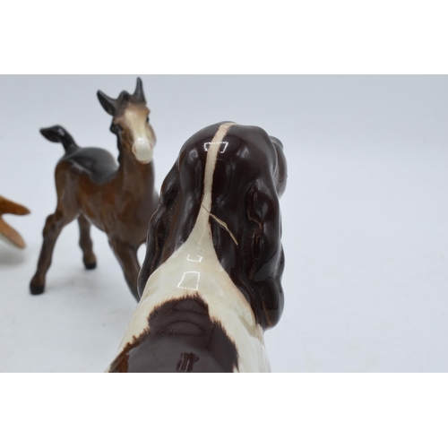 110 - A trio of Beswick animals to include barn owl 1046, large brown outstretched foal and cocker spaniel... 