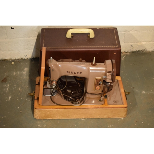 253 - A cased electric Singer sewing machine (untested).