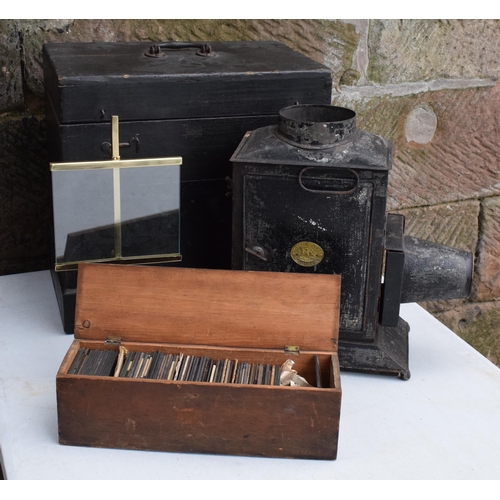 295 - A cased Negretti and Zambra magic lantern in wooden box with a box of slides with examples such as M... 