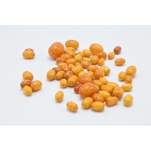 204 - A collection of amber-style beads, approximately 60 grams of varying shapes and sizes.