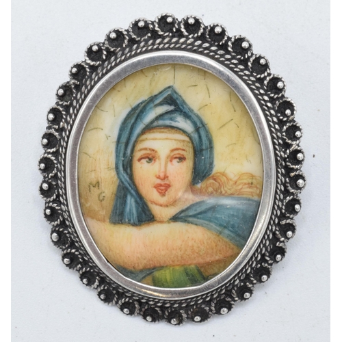 210 - An antique miniature portrait of a robed lady signed 'M G' in .800 silver brooch mount, 35mm tall.