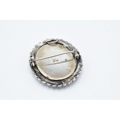 210 - An antique miniature portrait of a robed lady signed 'M G' in .800 silver brooch mount, 35mm tall.