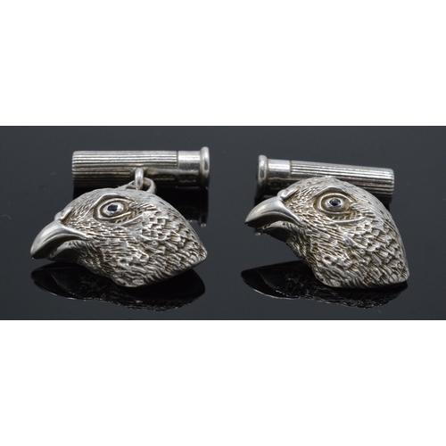 210L - A pair of hallmarked silver cufflinks in the form of grouse heads set with blue sapphires for eyes w... 