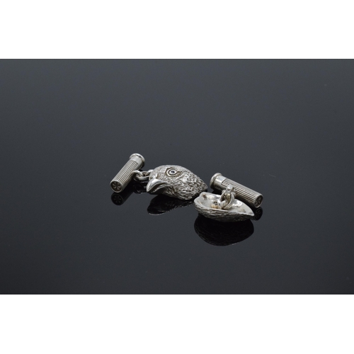 210L - A pair of hallmarked silver cufflinks in the form of grouse heads set with blue sapphires for eyes w... 