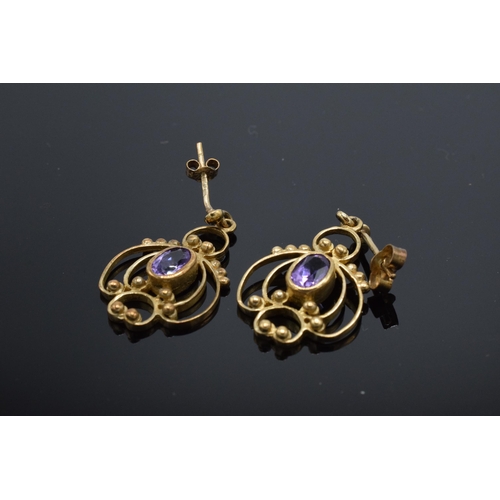 211 - 9ct gold drop-pendant earrings set with amethyst stones, 3.4 grams.