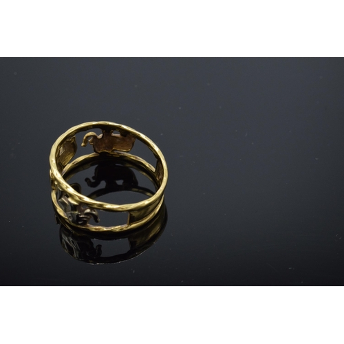 217 - 22ct gold and white gold ring with walking elephants, 3.3 grams, size P/Q. No hallmarks but it tests... 