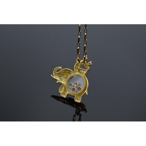 218 - 18ct gold elephant pendant set with CZs, rubies and sapphire stones on an 18ct gold chain, 6.4 grams... 