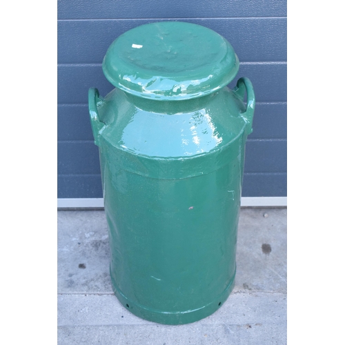 273 - A vintage metal milk churn painted in green colours, 72cm tall.