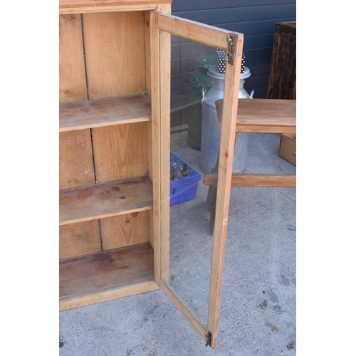 274 - An early 20th century tall pine display cabinet with glazed doors, 106x35x139cm tall.