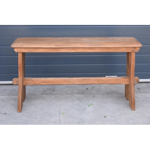 279 - A vintage 20th century pine bench / organ bench with shaped legs, 128cm wide and 75cm tall.