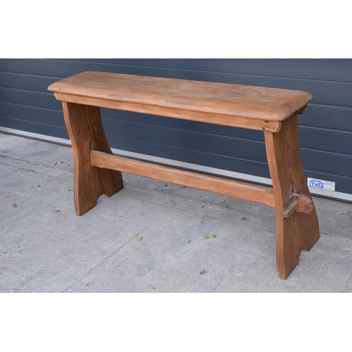 279 - A vintage 20th century pine bench / organ bench with shaped legs, 128cm wide and 75cm tall.