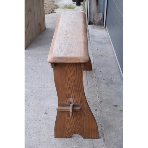 279 - A vintage 20th century pine bench / organ bench with shaped legs, 128cm wide and 75cm tall.