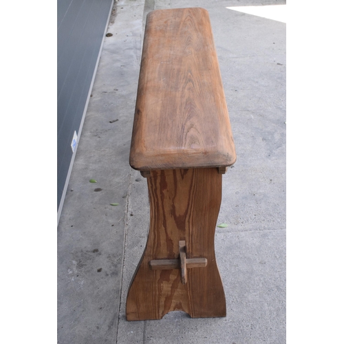 279 - A vintage 20th century pine bench / organ bench with shaped legs, 128cm wide and 75cm tall.