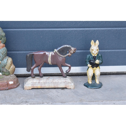 286 - A trio of painted cast metal door stops of varying forms (3).