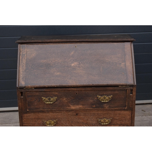 292 - A 1930s brown oak student's bureau, 89x39x103cm tall.