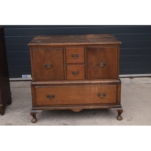 293 - A 1930s wooden unit consisting of drawers and cupbaords set on cabriole-style legs, 102x58x92cm tall... 