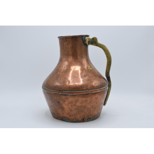 297 - 19th century copper and brass vessel / jug, 26cm tall.