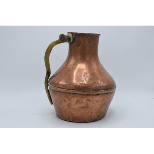 297 - 19th century copper and brass vessel / jug, 26cm tall.