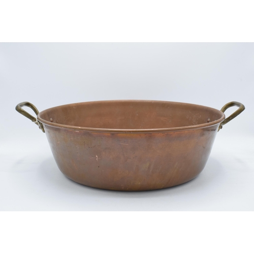 298 - An early 20th century copper and brass pan, 47cm wide.