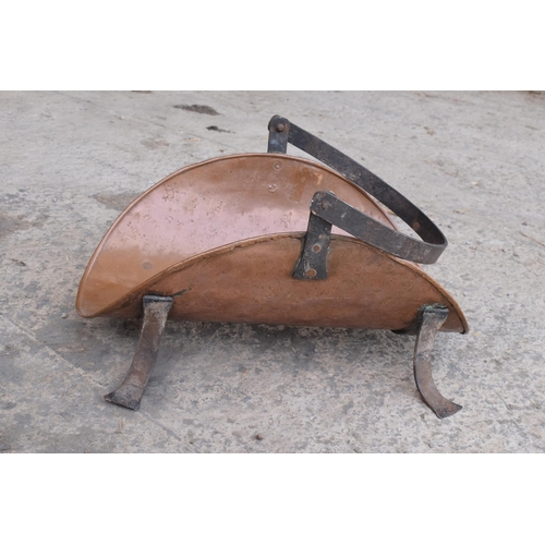 299 - A 19th century French copper and iron log basket on raised on four legs, 49cm long.