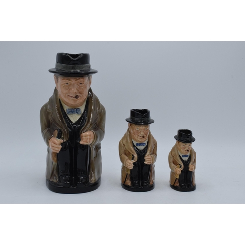 58 - A trio of graduated Royal Doulton Toby jugs of Winston Churchill, tallest 24cm.