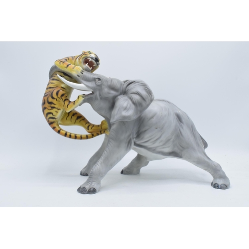 61 - A large Italian ceramic figure of an elephant and tiger by Ronzan, 29cm tall.