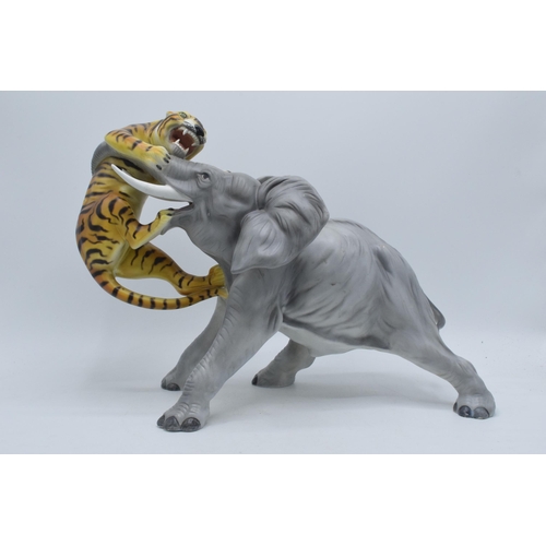 61 - A large Italian ceramic figure of an elephant and tiger by Ronzan, 29cm tall.