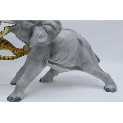 61 - A large Italian ceramic figure of an elephant and tiger by Ronzan, 29cm tall.