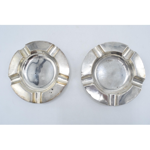 210N - A pair of silver circular ashtrays, Birmingham 1917, A J Zimmerman, 173.3 grams. 13cm wide.