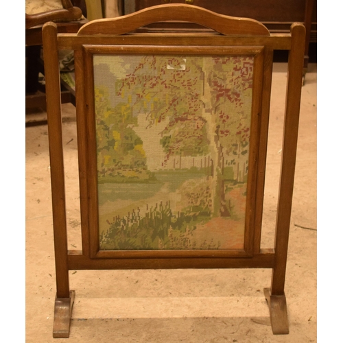 334 - A 20th century wooden fire screen with tapestry decoration, 79cm tall.