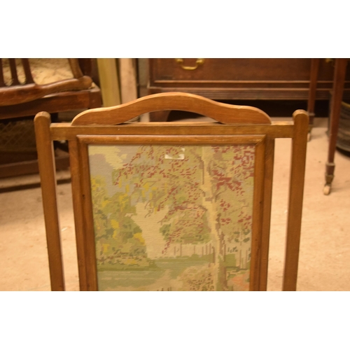 334 - A 20th century wooden fire screen with tapestry decoration, 79cm tall.