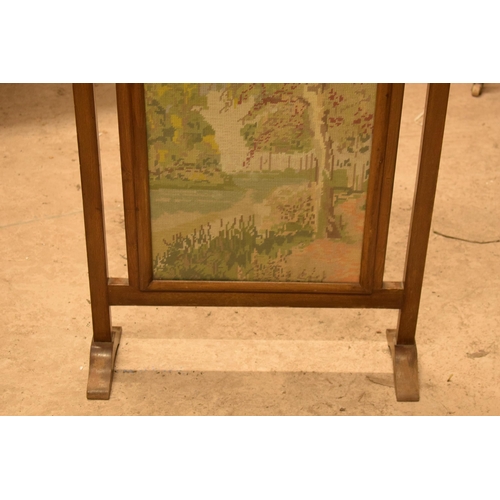 334 - A 20th century wooden fire screen with tapestry decoration, 79cm tall.