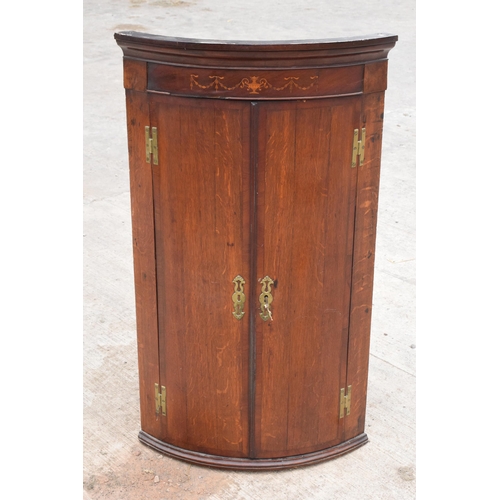 341 - A Georgian oak bow-fronted corner cabinet with inlaid decoration and shelves to interior and brass '... 