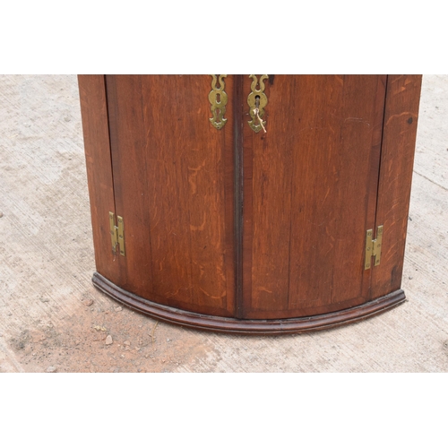 341 - A Georgian oak bow-fronted corner cabinet with inlaid decoration and shelves to interior and brass '... 