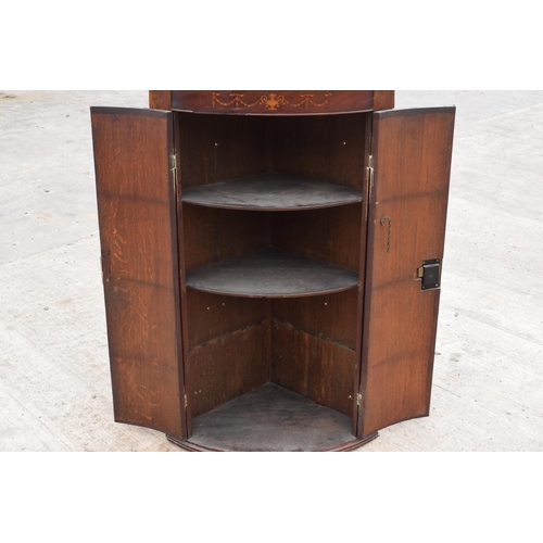 341 - A Georgian oak bow-fronted corner cabinet with inlaid decoration and shelves to interior and brass '... 