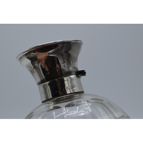 220C - A silver topped globular glass scent bottle with inlaid tortoiseshell lid, London 1916, 12cm tall.