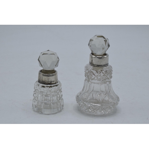 220T - A pair of miniature silver-rimmed scent bottles, London 1884 and Birmingham 1903, 8cm tallest (2).