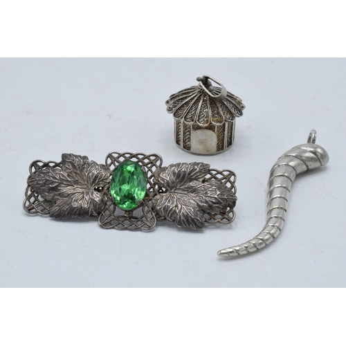 220Y - A silver filigree pendant in the form of a hut, a silver swirl pendant and a brooch set with a paste... 