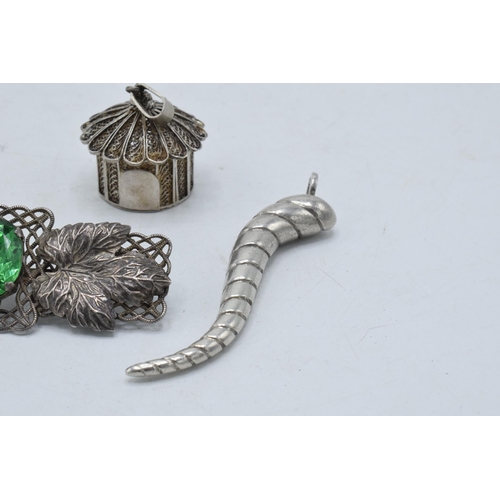 220Y - A silver filigree pendant in the form of a hut, a silver swirl pendant and a brooch set with a paste... 