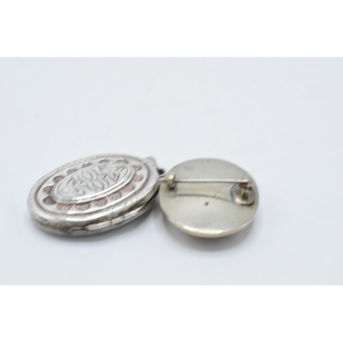 220Z - A silver locket together with a silver backed oriental scene brooch (2).