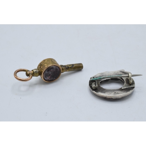 221A - A silver and agate buckle brooch together with a bloodstone watch key (2).