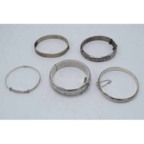 221E - A collection of 5 silver ladies bangles, 86.2 grams.