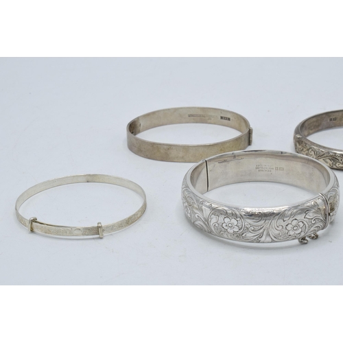 221E - A collection of 5 silver ladies bangles, 86.2 grams.