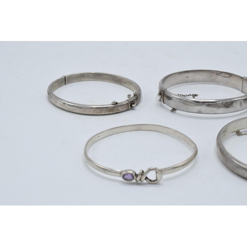 221F - A collection of 5 silver bangles, 62.2 grams.