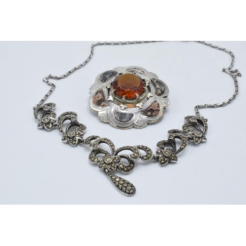 221H - A silver Scottish agate brooch (missing one section of agate) together with a silver marcasite neckl... 