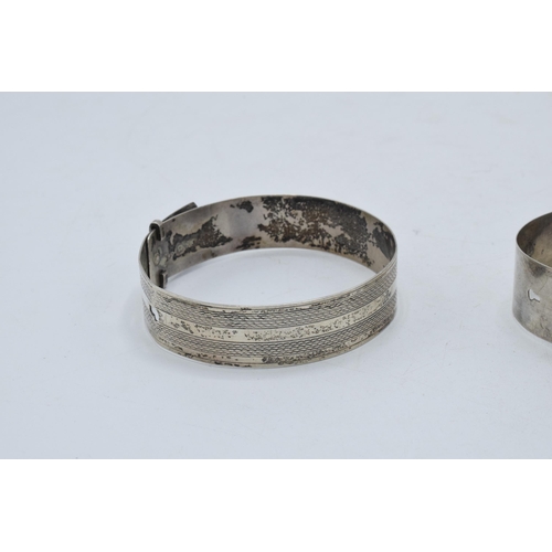 221I - A pair of silver buckle bangles (2).