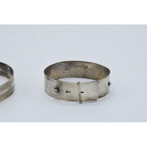 221I - A pair of silver buckle bangles (2).