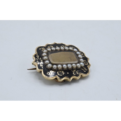 221O - Victorian gold mourning brooch set with pearls and black enamelling, gross weight 9.8 grams.