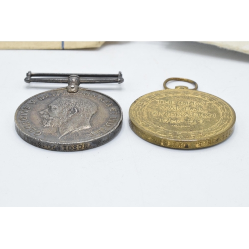 310I - A pair of World War One medals to include Victory medal and silver 1914-1918 medal with documents (2... 