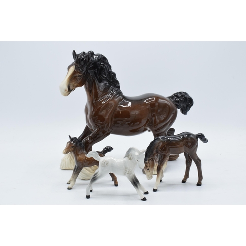 150 - A collection of Beswick horses to include brown cantering shire, brown outstretched foal, grey foal ... 